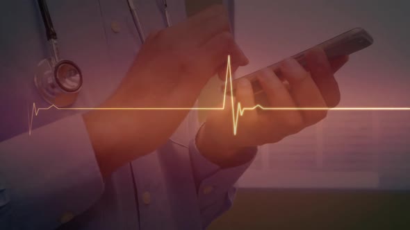 Red glowing heart rate monitor against mid section of male doctor using smartphone alt