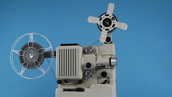 Rotating Vintage Movie Projector On A Blue Background
