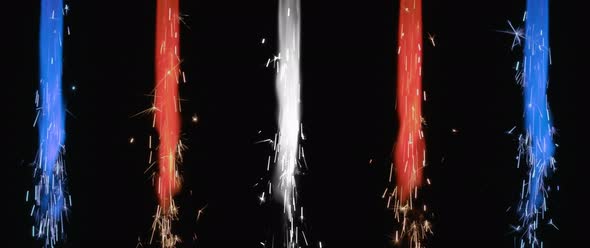 Colorful red, blue and white fireworks burning on the black background. alt