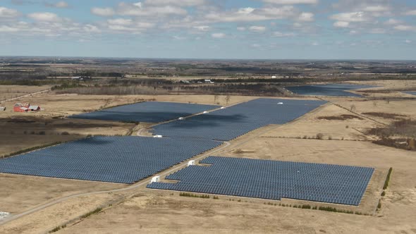 A bird's eye view of solar panels on the solar farm: they are gathering sunlight and turn it into en alt