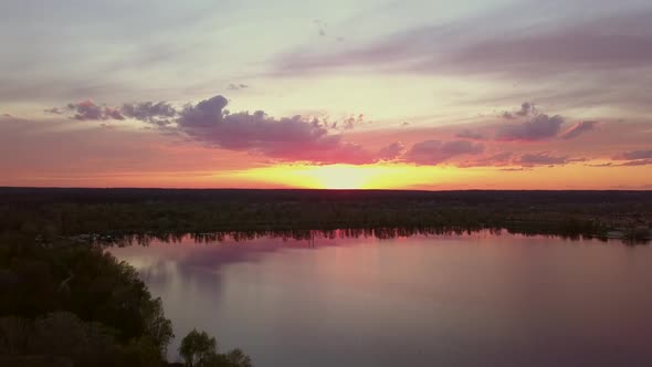 Colorful Sunset Over the Road with Cars Overlooking the Forest and Lake Ukraine Kiev on May 6 2021