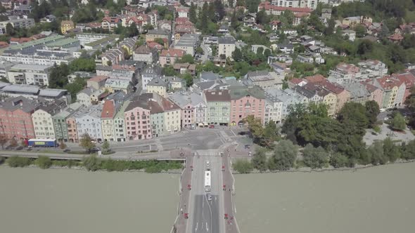 Aerial view of bridge over Inns river Innsbruck city Austria colorful houses Alps mountains