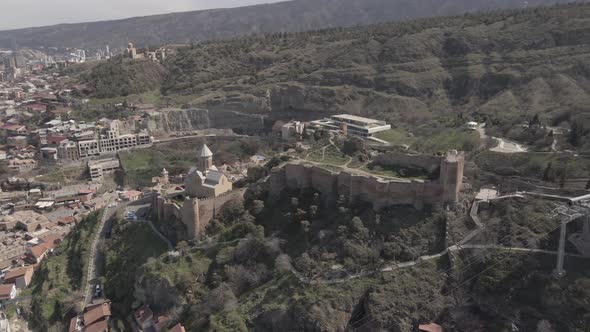 Capital Tbilisi old town buildings and Narikala fortress landmark on hill.Sightseeing in Georgia alt