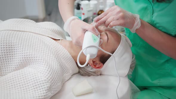 Beautician Woman Procedure for Cleansing and Rejuvenating Face in Beauty Salon alt