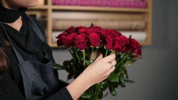 Focus on the Bunch of Red Roses Young Attractive Female Florist Arranging Bouquet of Beautiful Red alt