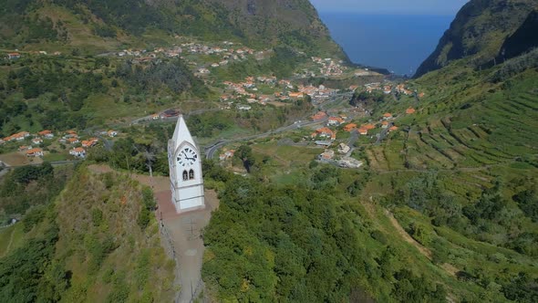 Beautiful Old Clock Tower on a Hill in Madeira with the Valley in the Distance alt