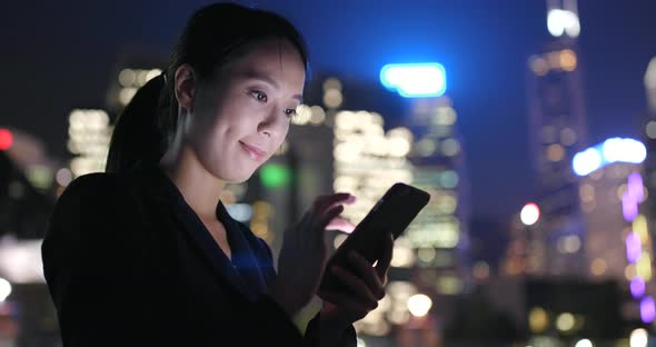 Woman Use Smart Phone in City at Night 