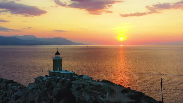 Drone Passing Light House At Sunset Melagkavi Greece 2 alt