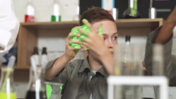 Laboratory Experience in a Chemistry Lesson, the Boy Playing with a Light Green Slime, Children's alt