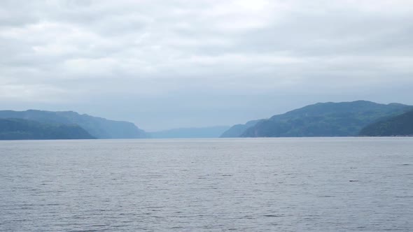 Panning Right To Reveal Large Body Of Water And Mountains In The Background alt