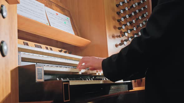 Organist Plays Music on Church Organ