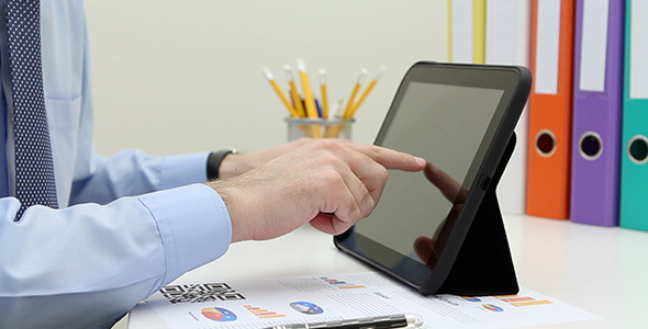 Man Reading News on Electronic Tablet