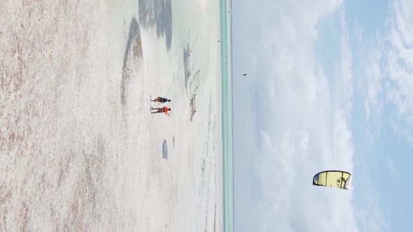 Vertical Video Kitesurfing Near the Shore of Zanzibar Tanzania Aerial View alt