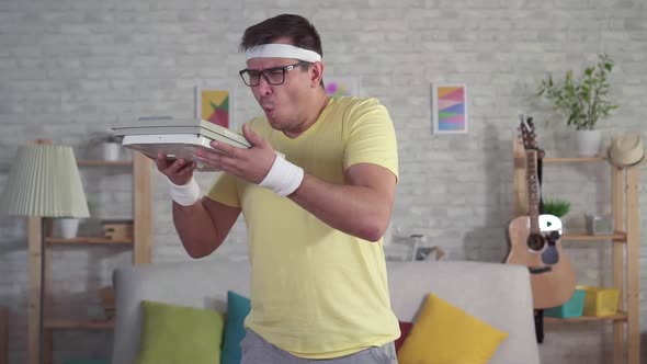 Expressive Funny Man in Sportswear Blows Dust Off Rarely Used Floor Scales Slow Mo alt