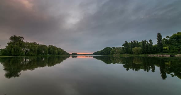 Timelapse of Beautiful Cloudy Sunrise in a Lake with Reflection alt