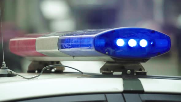 Flashing Flasher on the Roof of a Police Car. Blinker. Close-up. alt