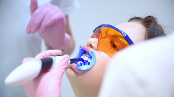 Woman Patient With Protective Glasses For Teeth Whitening Procedure