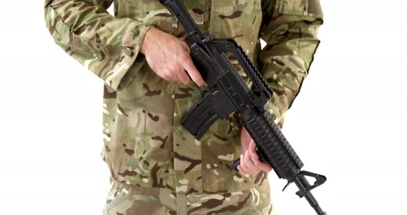 Soldier standing with rifle on white background alt