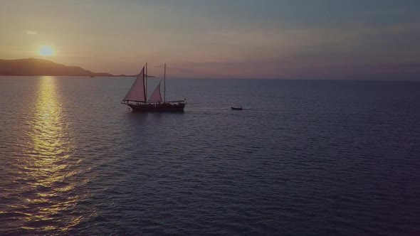 Colorful Sunset Above the Sea Surface with Sail Boats Aerial View