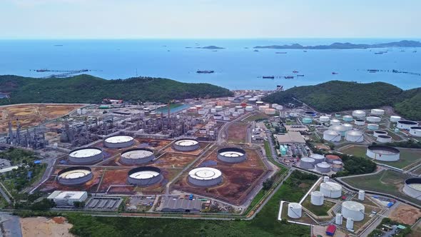 Aerial view of petrochemical oil refinery and sea in industrial engineering alt