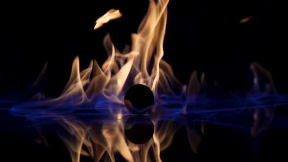 On a Black Reflective Background the Fire Ignites and Burns in Slow Motion alt