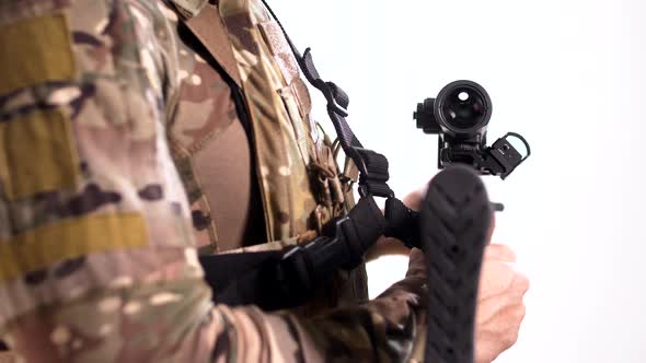 Combat rifle with two scopes, optical and collimator, in the hands of a soldie