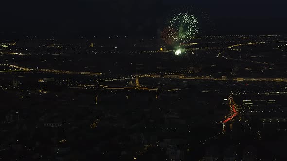 Bright Fireworks Over Night Cityscape with Reflection in the Rivers