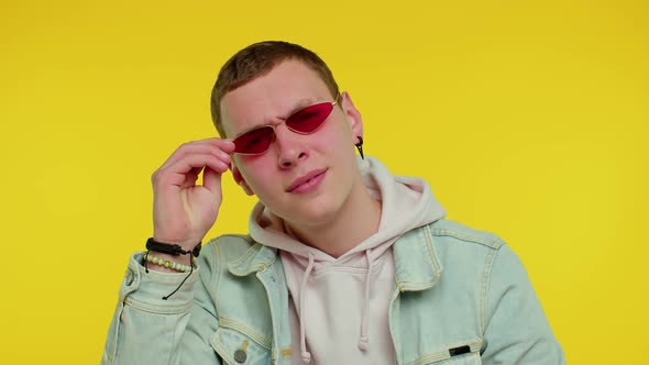 Handsome Man Wearing Sunglasses Blinking Eye Looking at Camera with Smile Winking and Flirting alt