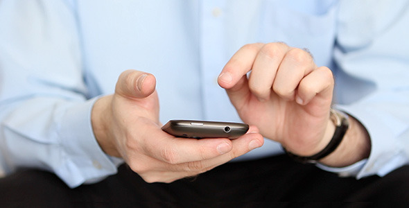 Businessman Text Messaging on Smartphone