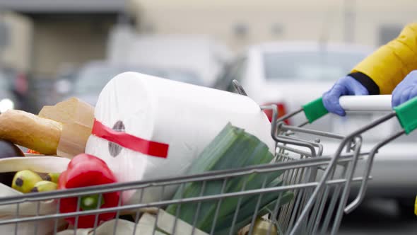 Tracking video of woman walking with full shopping basket.  Shot with RED helium camera in 8K alt