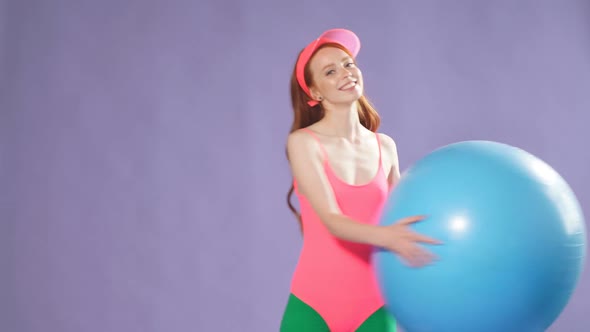 Sporty Cute Ginger Girl Making Exercises with Blue Fitness Ball Making Warming Up Workout alt