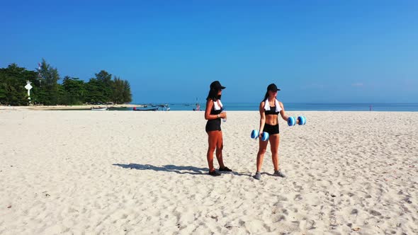 Women sunbathing on relaxing tourist beach adventure by blue lagoon and clean sand background of Koh alt