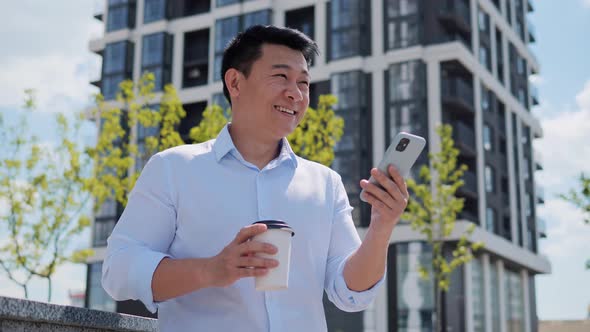 Handsome Asian Young Adult Entrepreneur Business Man Browsing Mobile Phone alt