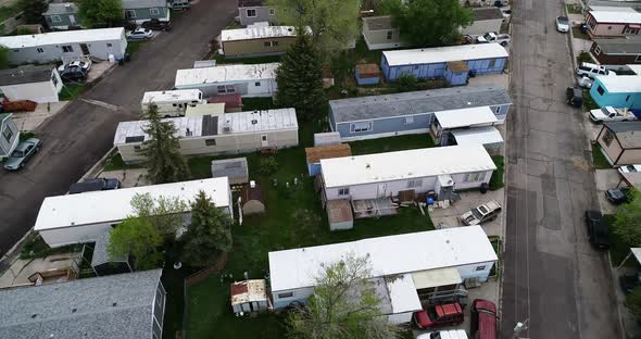 Run down single and double wide trailers in a mobile home park showing wealth disparity in 2021. alt