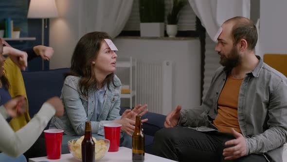 Gathering of Multiracial People Playing Board Game Using Stickey Notes alt