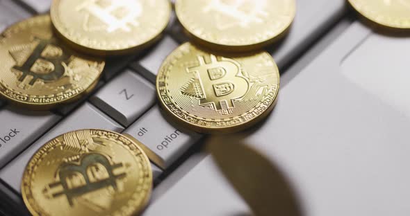 Bitcoin BTC Gold Coin Spins on Laptop Keyboard Slow Motion alt