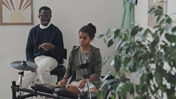 Teacher Watching Tween Play E-drums alt