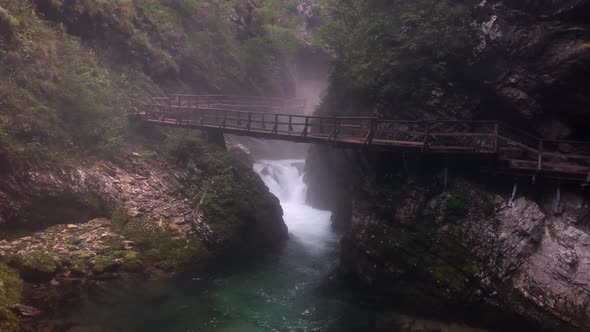 This is a 4k shot of a bridge going across the beautiful radovna river in slovenia in vintgar gorge. alt