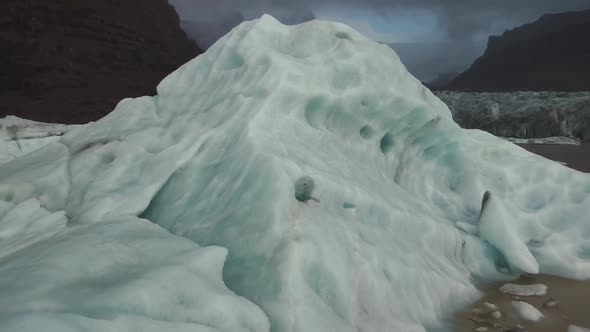 Dolly Zoom Over Iceberg with Hole with Glacier Tongue