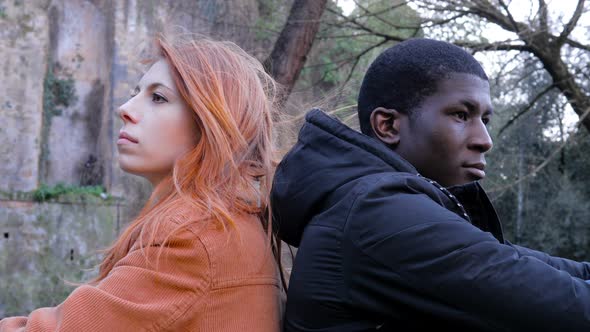 lovers Incommunicability concept.Mixed race couple after quarrel in the park alt