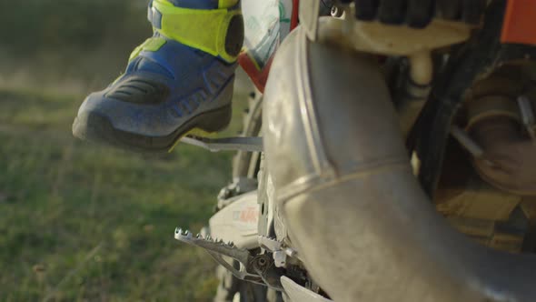 Leg of a rider on a motocross pedal alt