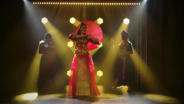 Girls Dance in Sexy Theatrical Costumes. Young Hot Brunettes with Long Hair. Bright Makeup and Red alt