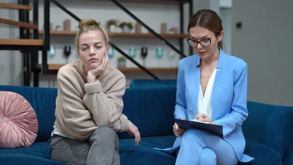 Portrait of Bored Teenage Girl Rolling Eyes As Professional Psychologist Giving Advice alt