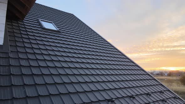 Closeup of House Roof Top Covered with Metallic Shingles alt