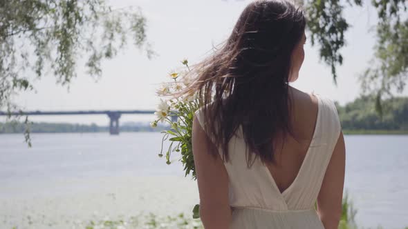 Portrait Young Girl with Long Brunette Hair Wearing a Long White Summer Fashion Dress alt