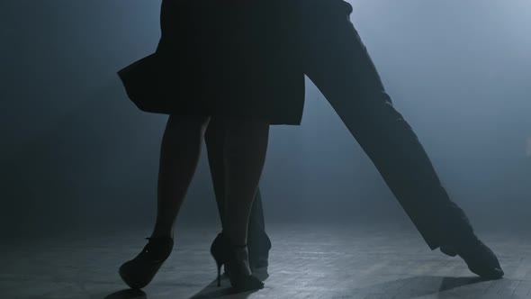Legs of Couple Dancing Tango in Dark Smoky Studio in Slow Motion in , UHD alt