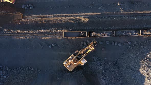 Excavator Loads Ore Into Freight Cars
