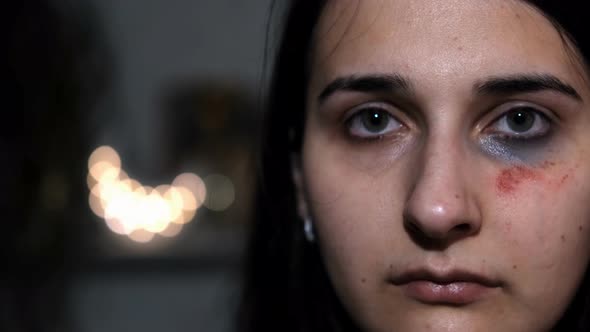 Slow motion portrait of a young female victim of domestic violence. Abrasions on the face