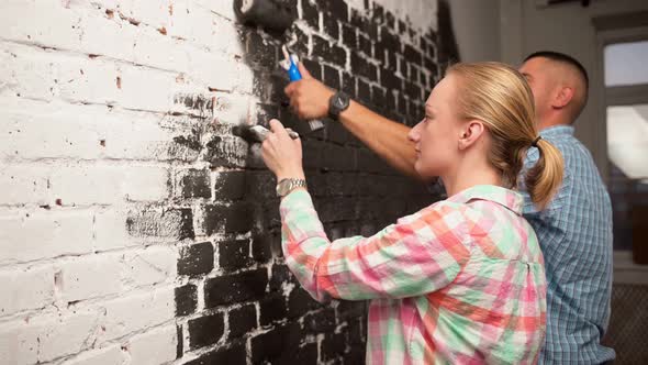Side View of White Multicultural Couple Doing House Renovation Together alt