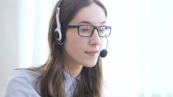 Young Woman Wearing Headphones Communicating Online Via Laptop Explaining Teaching alt